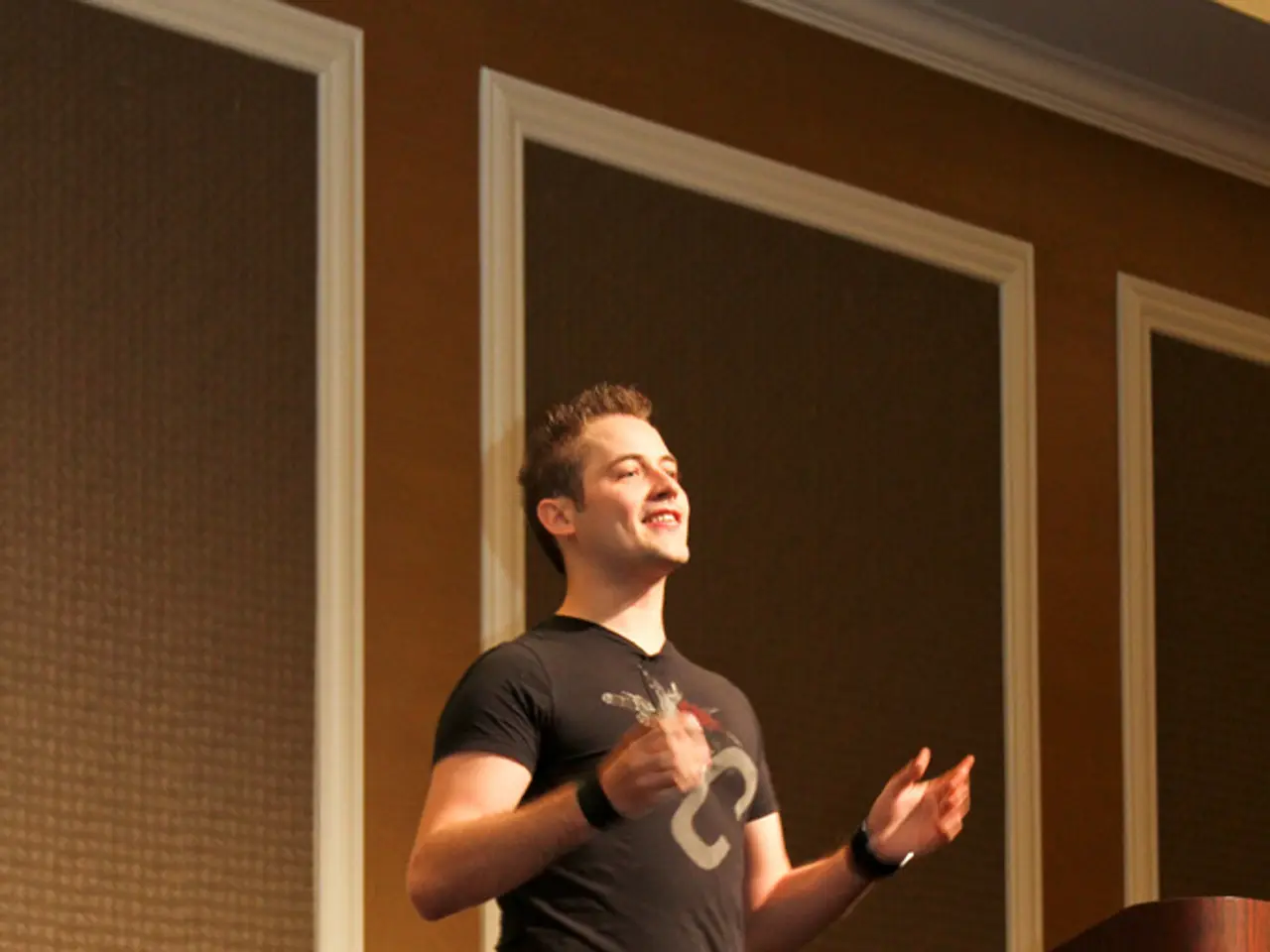 In this picture there is a man walking and smiling and we can see podium. In the background of the...