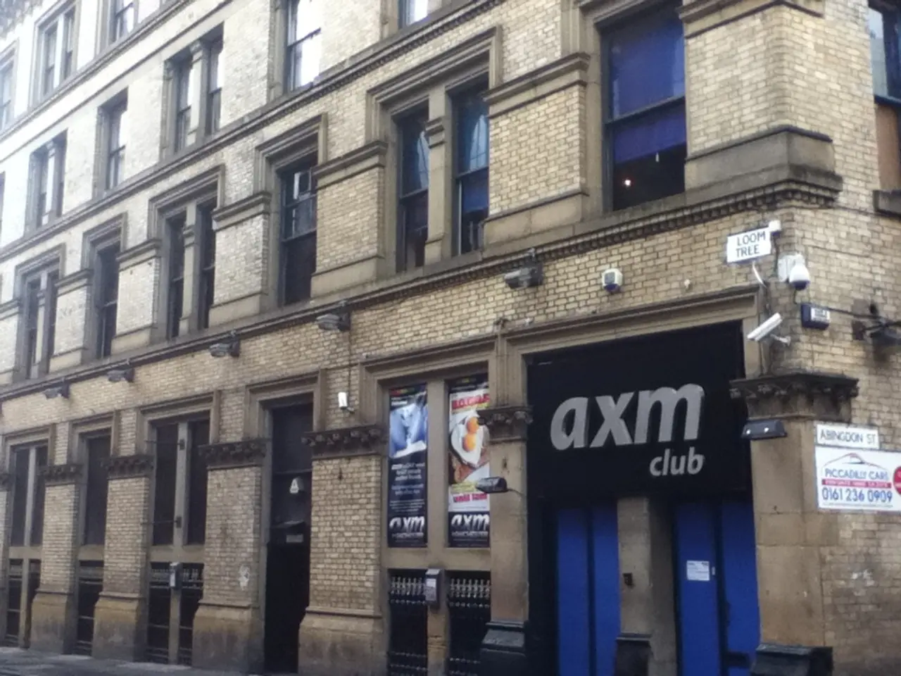 In this picture, it seems like a store, posters and a building in the foreground.