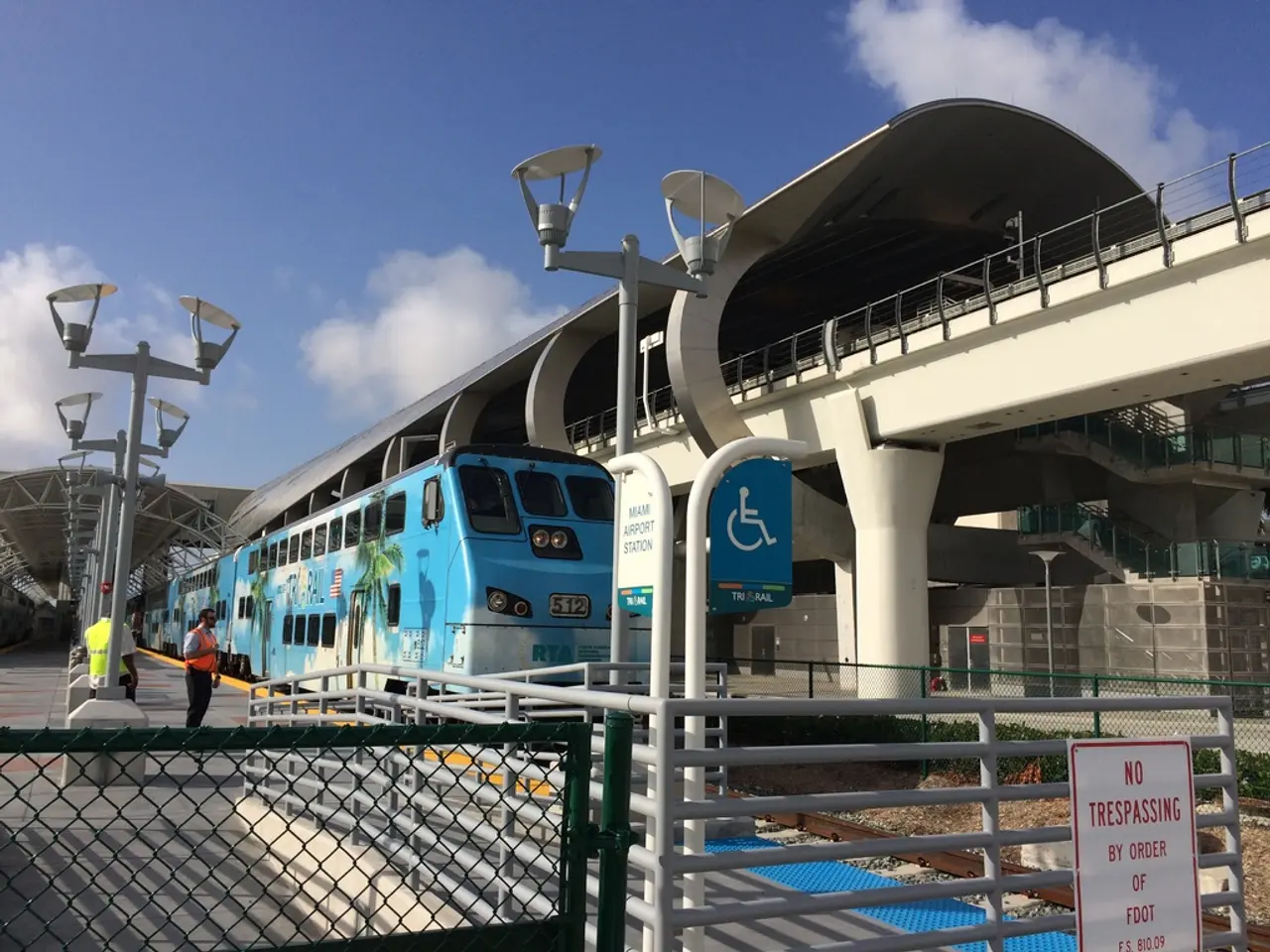 In this picture I can see there are a few people standing here at left side platform and there is a...