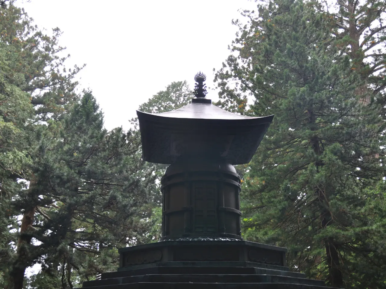 In the center of the image there is a black color memorial. In the background of the image there...