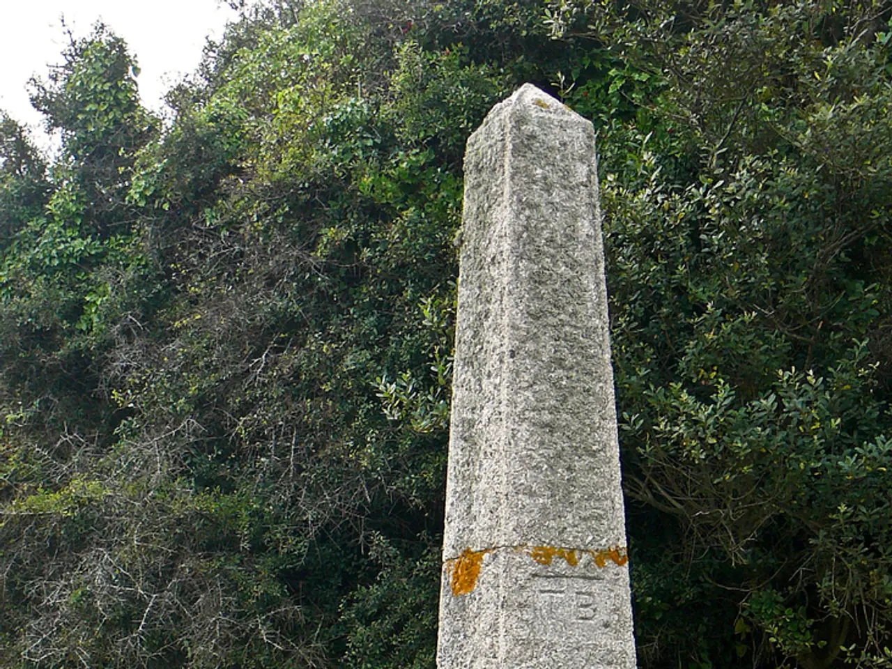 In the picture I can see column stone, there are some gravestones and in the background of the...