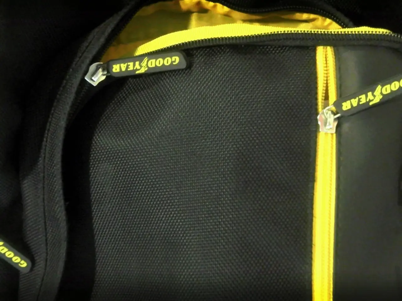 In the picture there is a black and yellow color bag,it looks like a college bag on the zip it is...