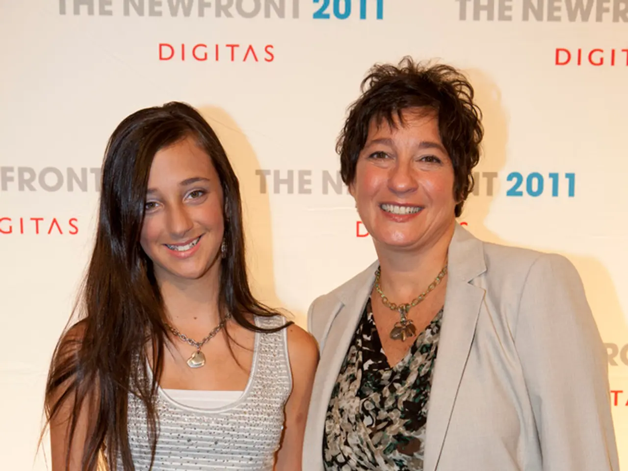 In this image, we can see two women standing, in the background, we can see a poster, there are...