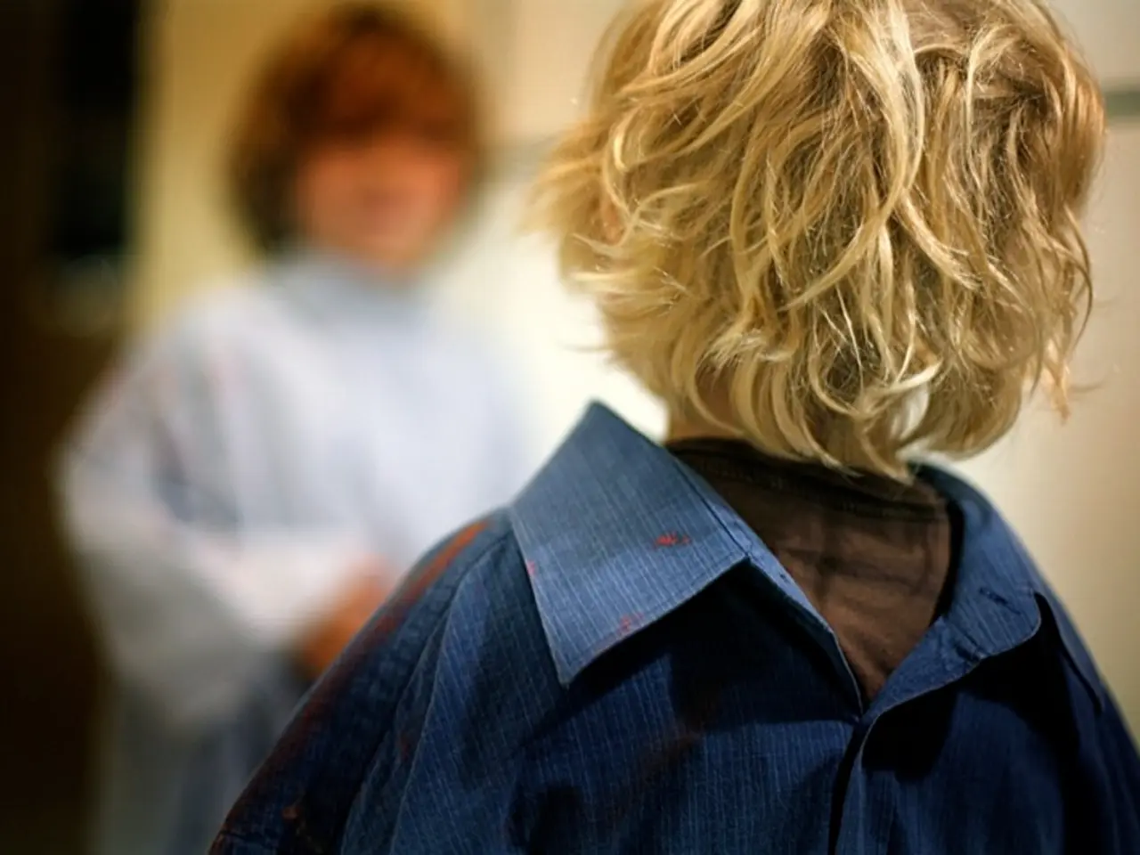 In this picture we can see two kids and blurry background.