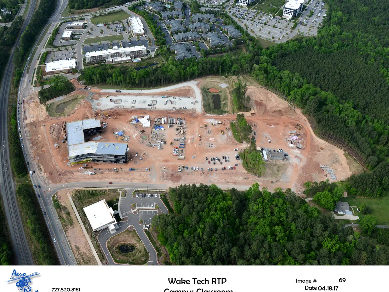 The image shows an aerial view of Wake Tech RTP Campus Classroom, with buildings, trees, roads,...