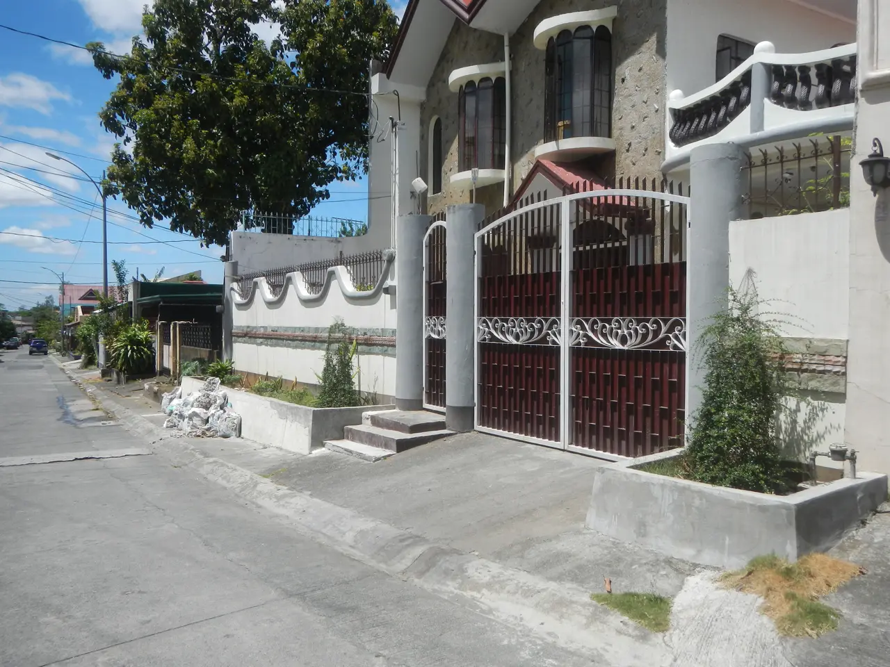 The image shows a house for sale in Cebu City, Philippines. It has windows, railings, pillars and a...