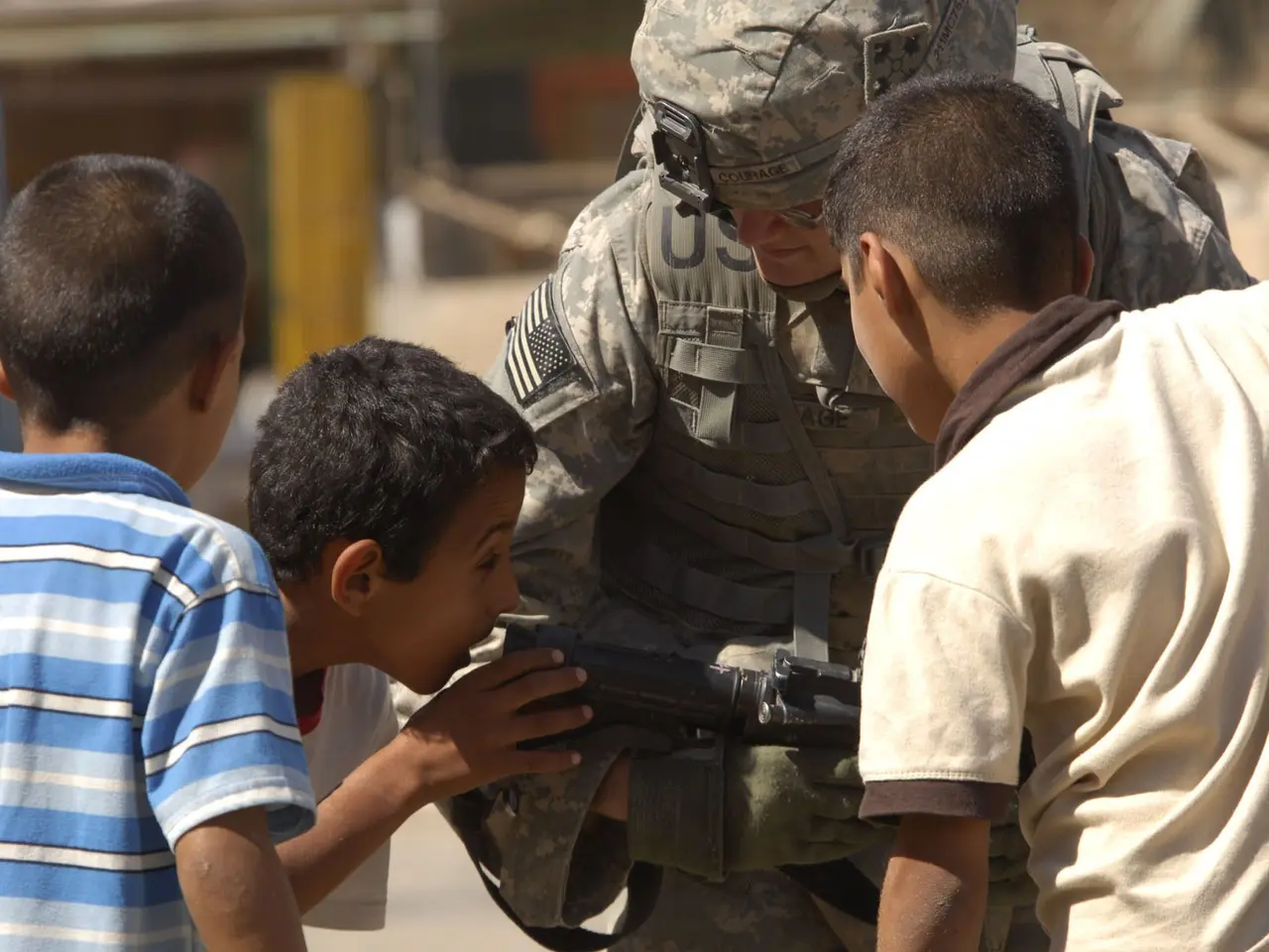 The image shows a soldier wearing a military uniform and a helmet, holding a gun in his hand,...