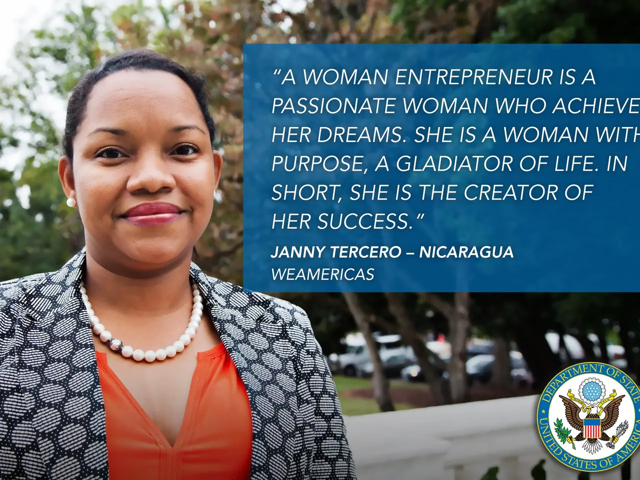 The image shows a woman entrepreneur wearing a black and white jacket and an orange dress, standing...