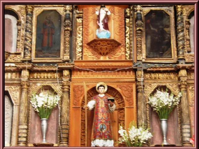 In this picture we can see sculptures, flowers and frames on the wall.