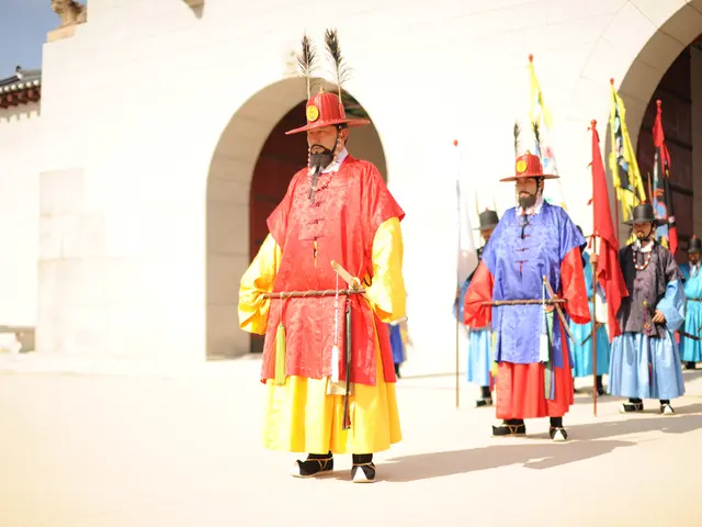 This picture shows few people standing and we see hats on their heads and few of them holding flags...