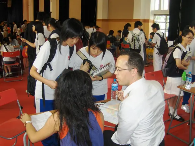 In this picture we can see the view of the classroom. In the front there are some girls, wearing a...