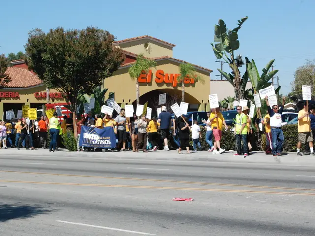There are group of people holding placards and walking. These are the trees. I can see small...