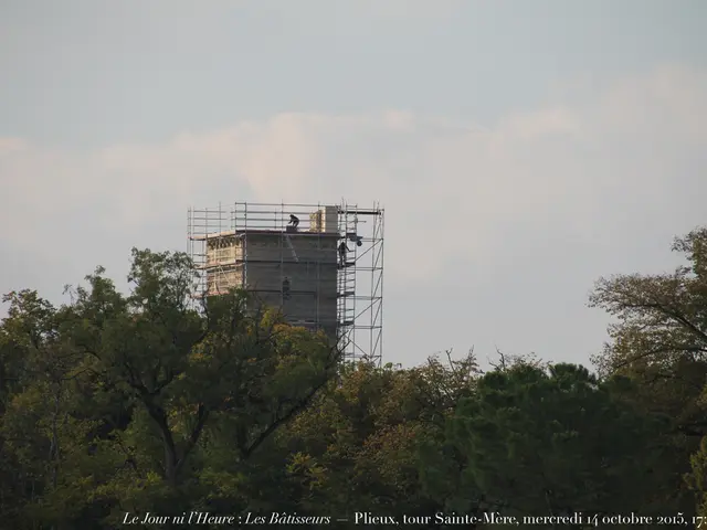 In this image there are some trees in the bottom of this image and there is one construction...
