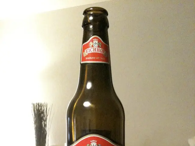 there is a glass bottle on which pony name label is attached. behind the bottle there is a white...