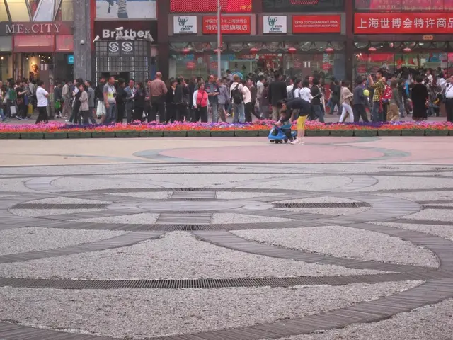 In this picture I can see a kid riding the toy vehicle, in the middle there are people. In the...