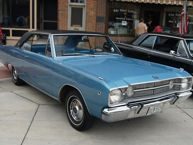 This picture contains two cars which are in blue and black color and these cars are parked on the...