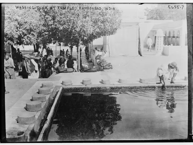 The image shows a black and white photo of a group of people washing their hands in a pool...