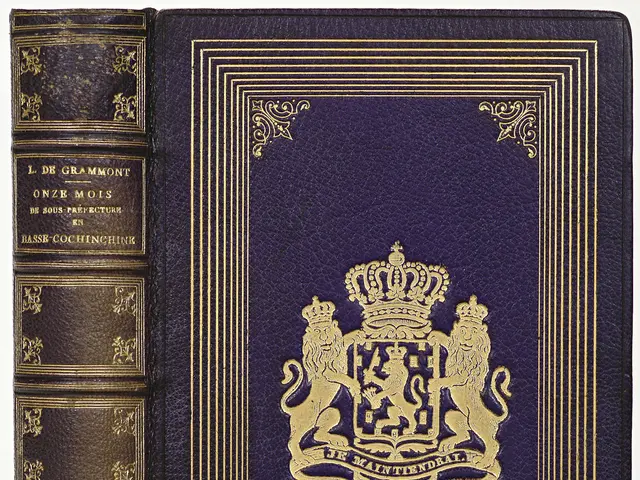 The image shows a blue book with a gold crown on top of it, set against a white background. The...