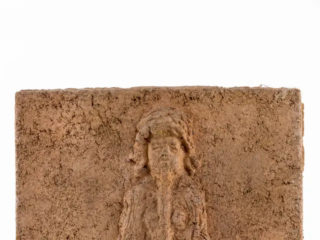 The image shows a stone relief of a woman sitting in a lotus position, with a white background and...