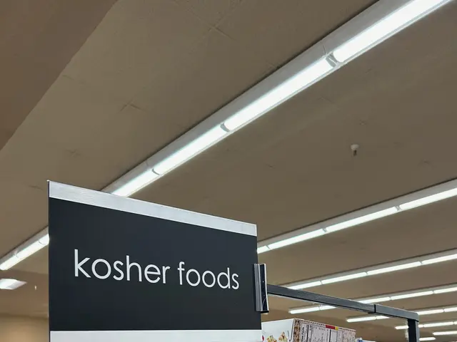 The image shows a store filled with lots of different types of kosher foods, including bottles,...