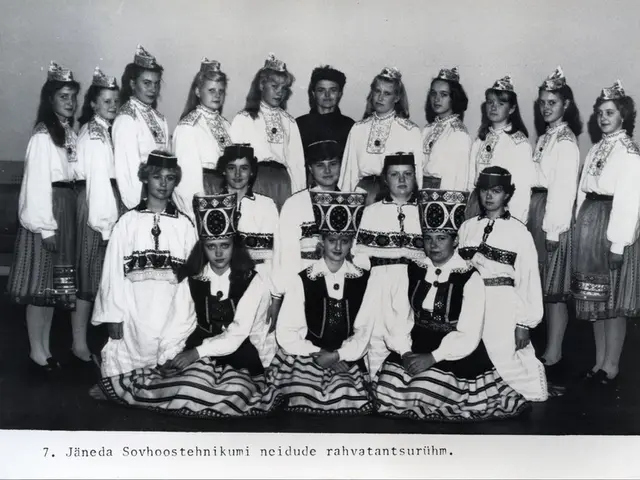 The image shows a group of women in traditional Romanian costumes posing for a photo in front of a...