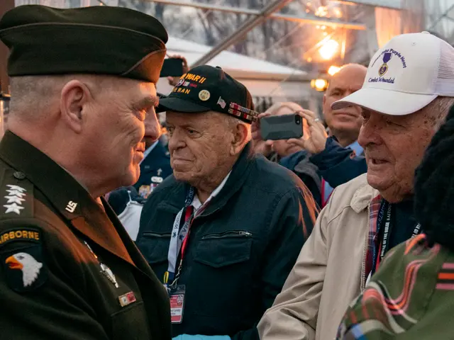 The image shows a group of men in military uniforms talking to each other. Some of them are wearing...