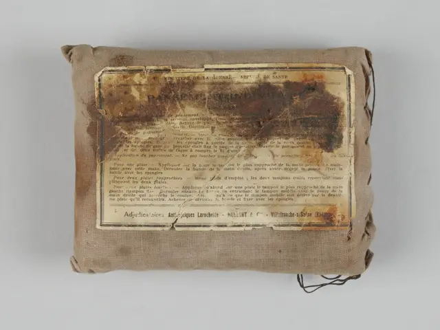 The image shows a small bag with a piece of paper on top of it, which appears to be a first-aid...