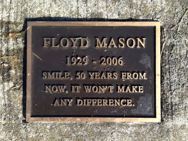 The image shows a plaque on the side of a building that reads "Floyd Mason". The plaque is made of...