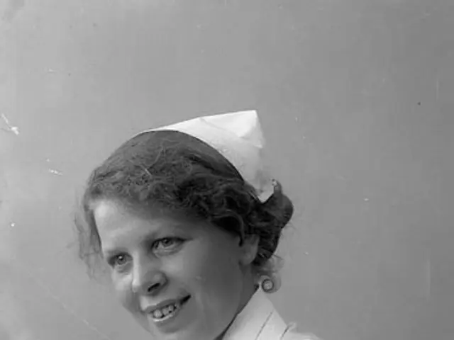 The image shows a black and white photo of a woman in a nurse's uniform, smiling. She is wearing a...