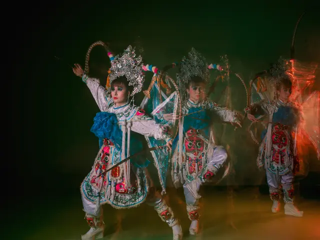 The image shows a group of three women in traditional Chinese costumes performing a dance on a...