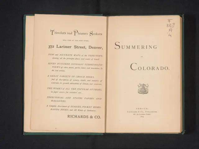 The image shows an open book with the words "Summering in Colorado" written on it against a black...