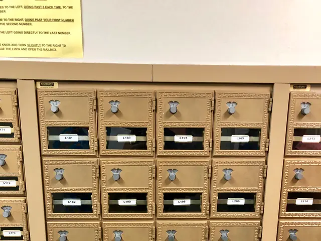 The image shows a large number of mailboxes stacked on top of each other, with a paper pasted on...