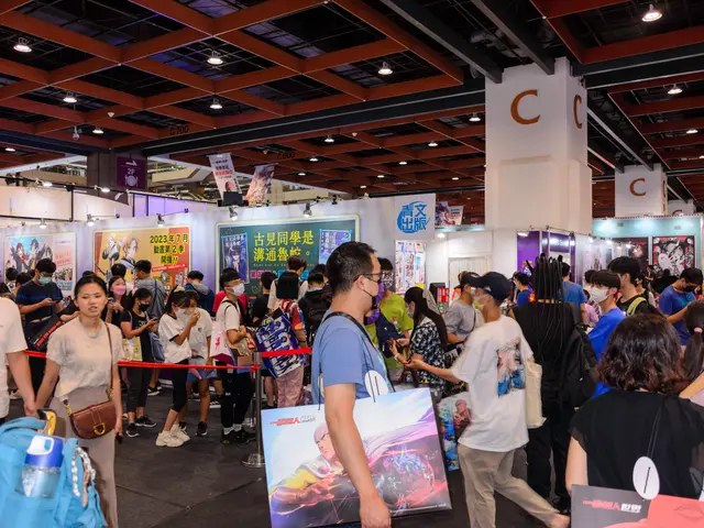 The image shows a large group of people standing in front of a booth, some of them holding bags and...
