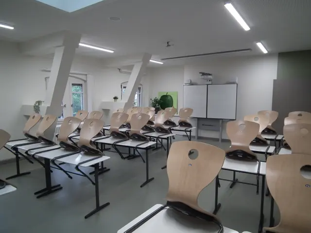 The image shows a classroom with rows of chairs arranged in neat rows, a whiteboard in the...