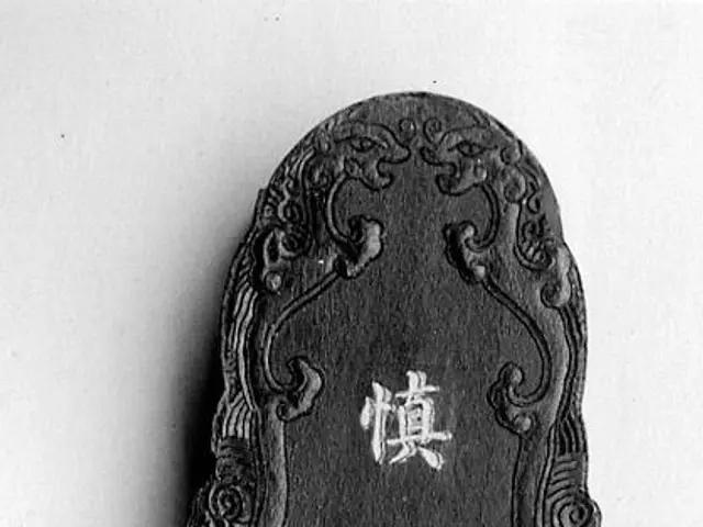 The image shows a black and white photo of a plaque with Chinese writing on it. The plaque is...