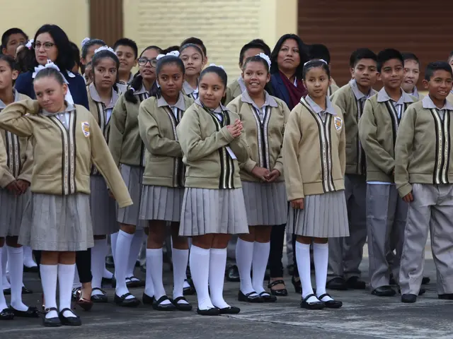The image shows a group of children standing next to each other in front of a building, with a wall...