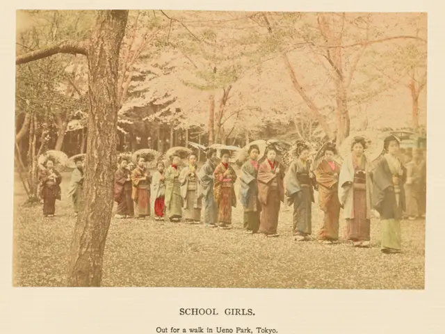 The image shows a group of school girls walking in Ueno Park, Tokyo, with umbrellas in hand. The...