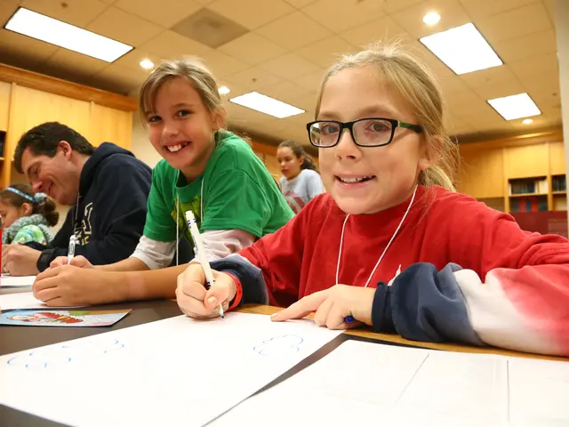 The image shows a group of children sitting at a table in a library, surrounded by bookshelves...