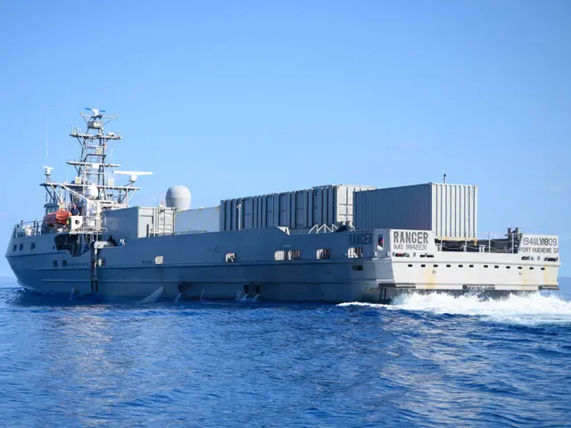 The image shows a large ship in the ocean with a blue sky in the background. On the ship, there are...