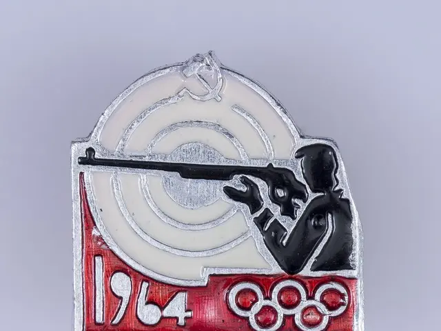 The image shows a badge with a picture of a man holding a rifle in front of a target, with the text...