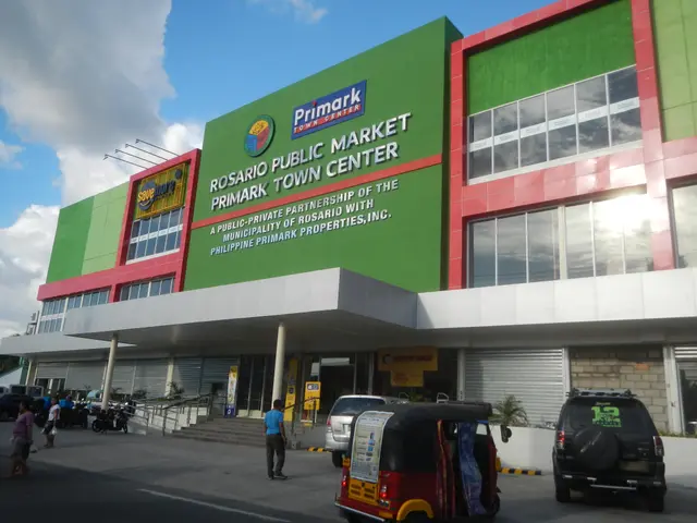 The image shows the Rosario Public Market in Manila, Philippines. It is a large building with glass...