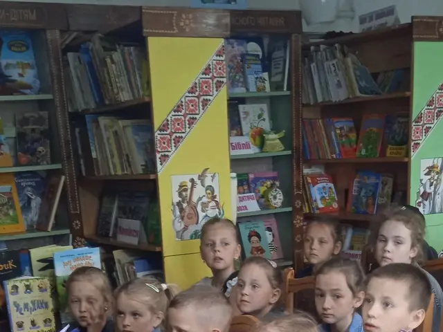 The image shows a group of children sitting in a library, surrounded by bookshelves filled with...