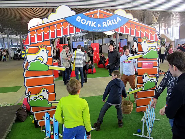 The image shows a group of people standing around a carnival tent, with some of them holding...