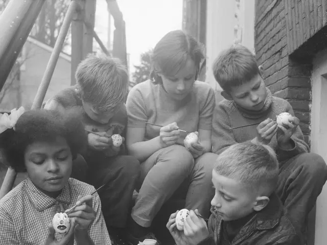 The image shows a group of children sitting on the steps of a house, painting Easter eggs. The...
