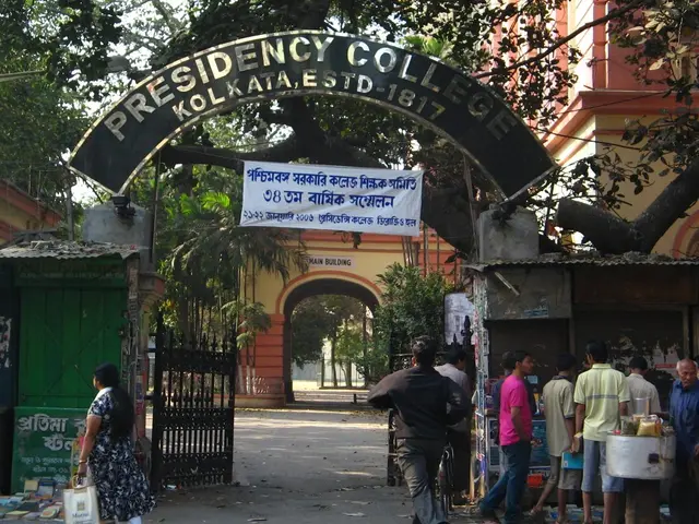 The image shows the entrance to Presidency College in Kolkata, India. There is an arch with a...