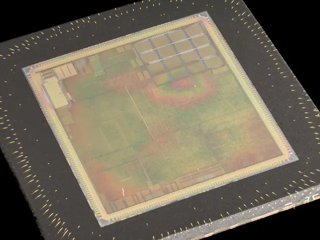 The image shows a close up of a semiconductor chip on a black background. The chip is rectangular...