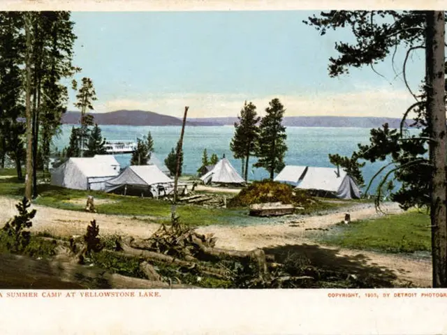 The image shows a summer camp at Yellowstone Lake, with tents set up on the shoreline surrounded by...