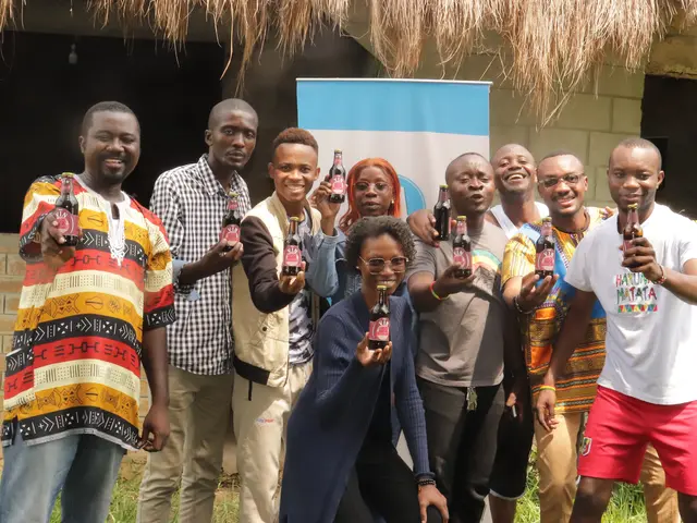 The image shows a group of people standing next to each other in front of a building, smiling and...