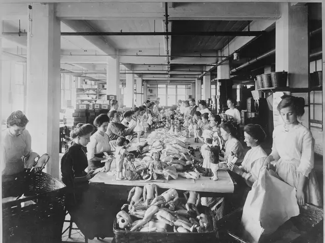 The image shows a black and white photo of a group of women working in a factory. There are dolls...