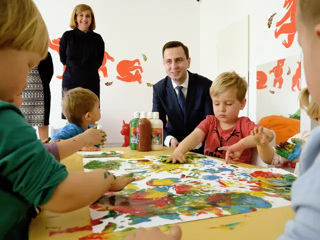 The image shows a group of children sitting around a table with paint on their hands. On the table...
